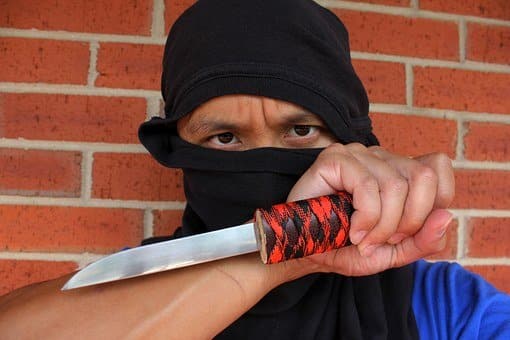 Male ninja holding blade-blue top-black head cover