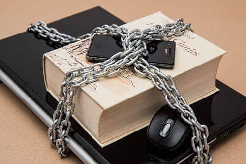 Laptop-book-mobile phone-mouse-tied up in chain