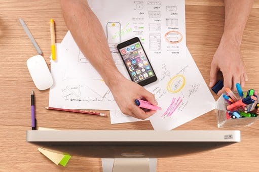 design industry-mobile-desktop-pens-pencils-eraser-paper-hands